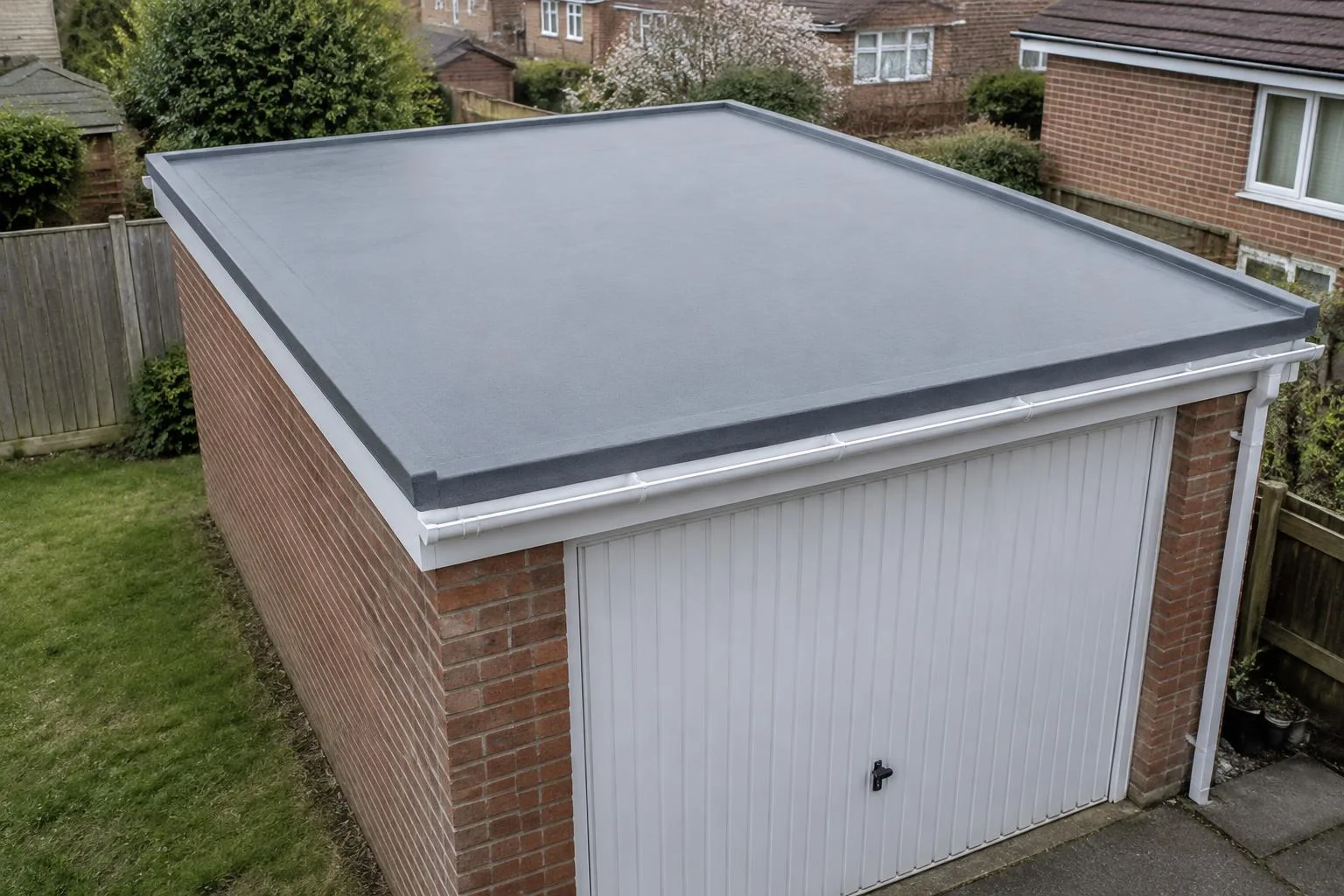 Grey seamless flat roof on a red-brick garage in a UK garden. AI-generated illustration, not an LMB project.